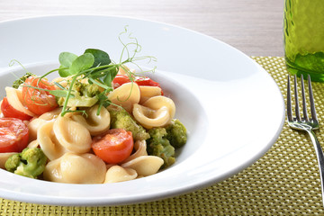 Orecchiette with cherry tomatoes, broccoli and anchovies, Italian food 