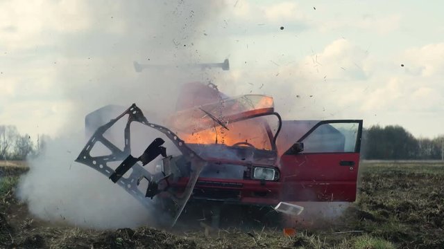 Car Explosion. Car blasts into the field. Slow Motion. Front View.