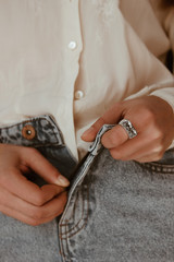 Woman hands zipping blue jeans