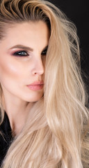 Obraz premium Strong make up on strong face and messy long blonde hair.