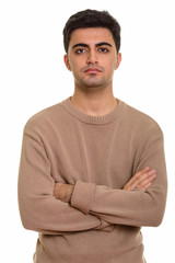 Young handsome Persian man looking at camera