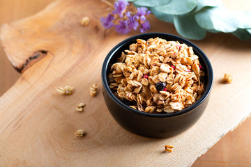Food breakfast concept Organic Muesli or Granola on black ceramic cup