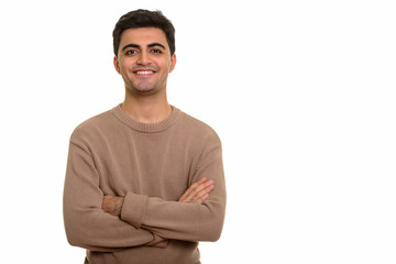 Young happy Persian man smiling with arms crossed