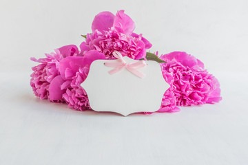 Pink peonies and wooden decorative plate