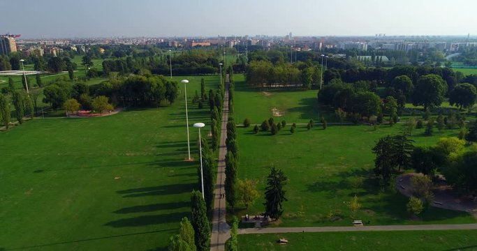 Aerial view of countryroad through green field 4k