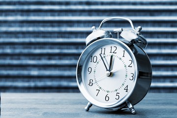 Retro alarm clock on table  background