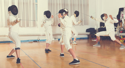 Fototapeta premium Boys and adults practicing fencing techniques