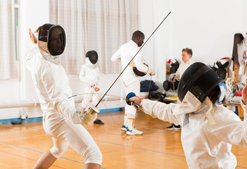 Active group  practicing fencing techniques