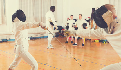 Fototapeta premium Young fencers training with coach