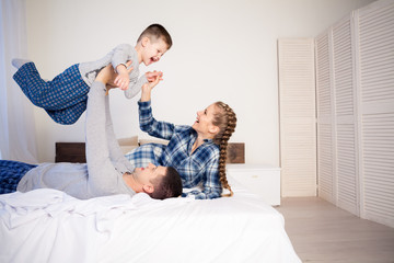 mom dad and young son in the bedroom after sleeping House