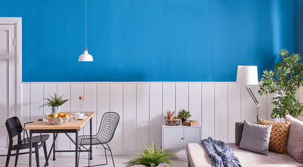 White and blue wall background dining table and white lamp.