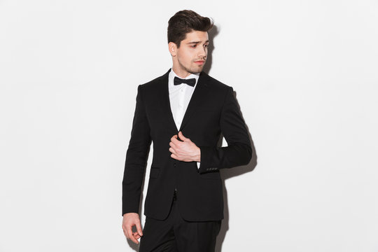 Portrait of a handsome young man wearing black suit