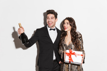 Cheerful young smartly dressed celebrating