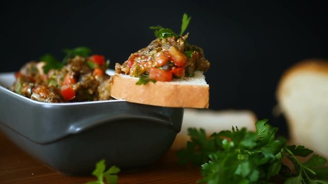 eggplant caviar with tomatoes and a slice of bread