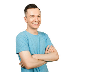 Portrait of young smiling guy with crossed arms isolated on a white background.