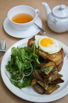 Breakfast of Croque Madame with potatoes and salad