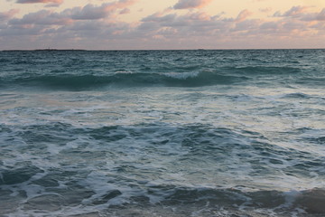 The Atlantic Ocean. off the coast of Cuba, early morning. light cloud cover, pink sky.