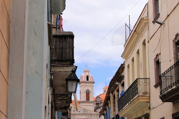 Fototapeta na wymiar Looking down a street along the tops of buildings to the Havana Cathedral, Havana, Cuba.