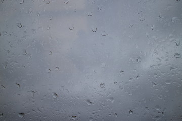 gray autumn sky drops on a window pane