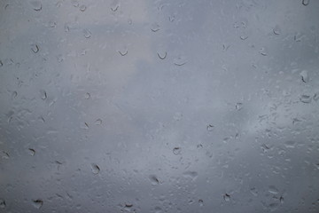 gray autumn sky drops on a window pane