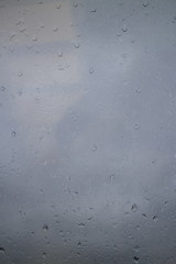 gray autumn sky drops on a window pane