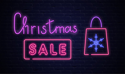 Christmas sale pink neon promo poster with shopping bag on brick textured background.