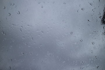 gray autumn sky drops on a window pane