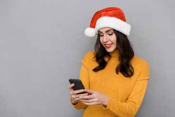 Portrait of a smiling woman wearing red santa claus hat