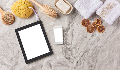 Obraz na płótnie Canvas Technological tool tablet phone screen on the marble floor and bathroom spa product.