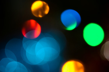 Bokeh. Christmas tree lights. Holiday background. Garland. Glitter. Christmas eve. Defocused sparkles. New Year backdrop. Blinks. Carnival. Bokeh retro style photo.