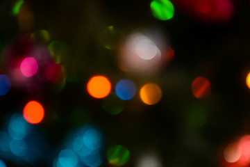 Obraz premium Bokeh. Christmas tree lights. Holiday background. Garland. Glitter. Christmas eve. Defocused sparkles. New Year backdrop. Blinks. Carnival. Bokeh retro style photo.