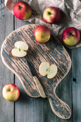 A group of apples on a cutting board