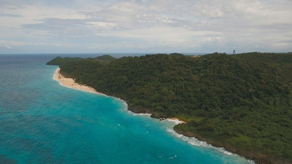 Aerial view of beautiful tropical island with white sand beach, hotels and tourists, Boracay, Puka shell beach. Tropical lagoon with turquoise water and white sand. Beautiful sea, beach, resort