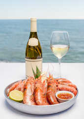 Royal shrimps with wine against the background of the sea
