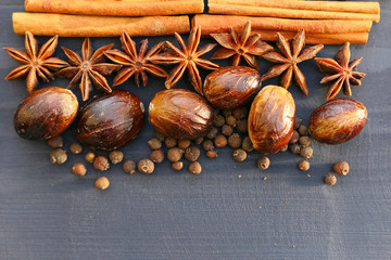 Christmas or pumpkin spices on wooden background.