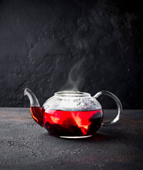 Red hibiscus flower tea in glass teapot  © Yulia Furman