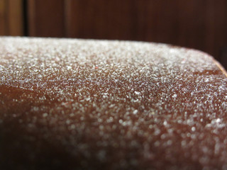 Close up of dust on wooden table . Dusty surface
