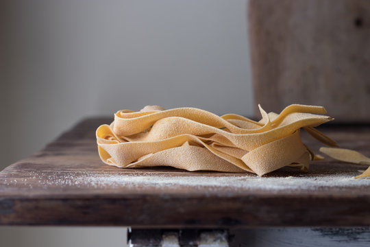 Heap of uncooked pappardelle on table