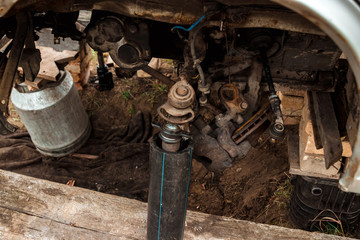 The car is lifted on jacks without wheels. Repair, tire installation.