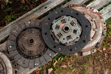 Clutch discs on a wooden background, car repair.