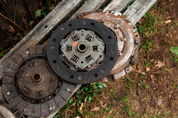 Clutch discs on a wooden background, car repair.