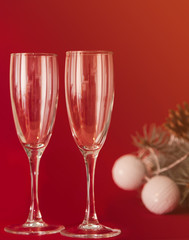 Champagne and wineglasses on red background.
