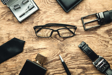 Men's accessories on a wooden background.