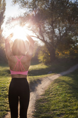 Young woman practicing yoga in the park in the open air. Yoga on the nature. selective focus