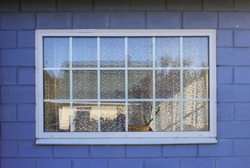 Fototapeta na wymiar small glass windows on the vernada of a wooden private summer house