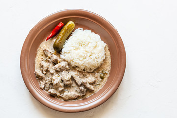 portion of Beef Stroganoff on white with copyspace
