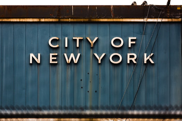 inscription city of new york on metal wall