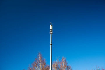 Telecommunication tower with blue sky and cloud