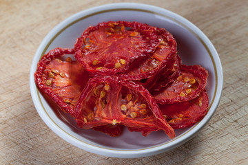 Sun dried tomatoes on wooden background