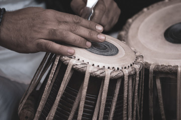 Images of a man's hands (wearing beads) playing the Tabla - Indian classical music percussion...